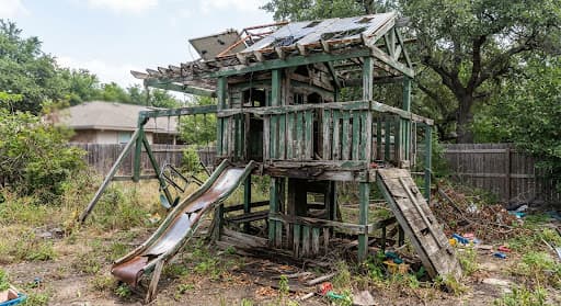 Weathered wooden playground before demolition